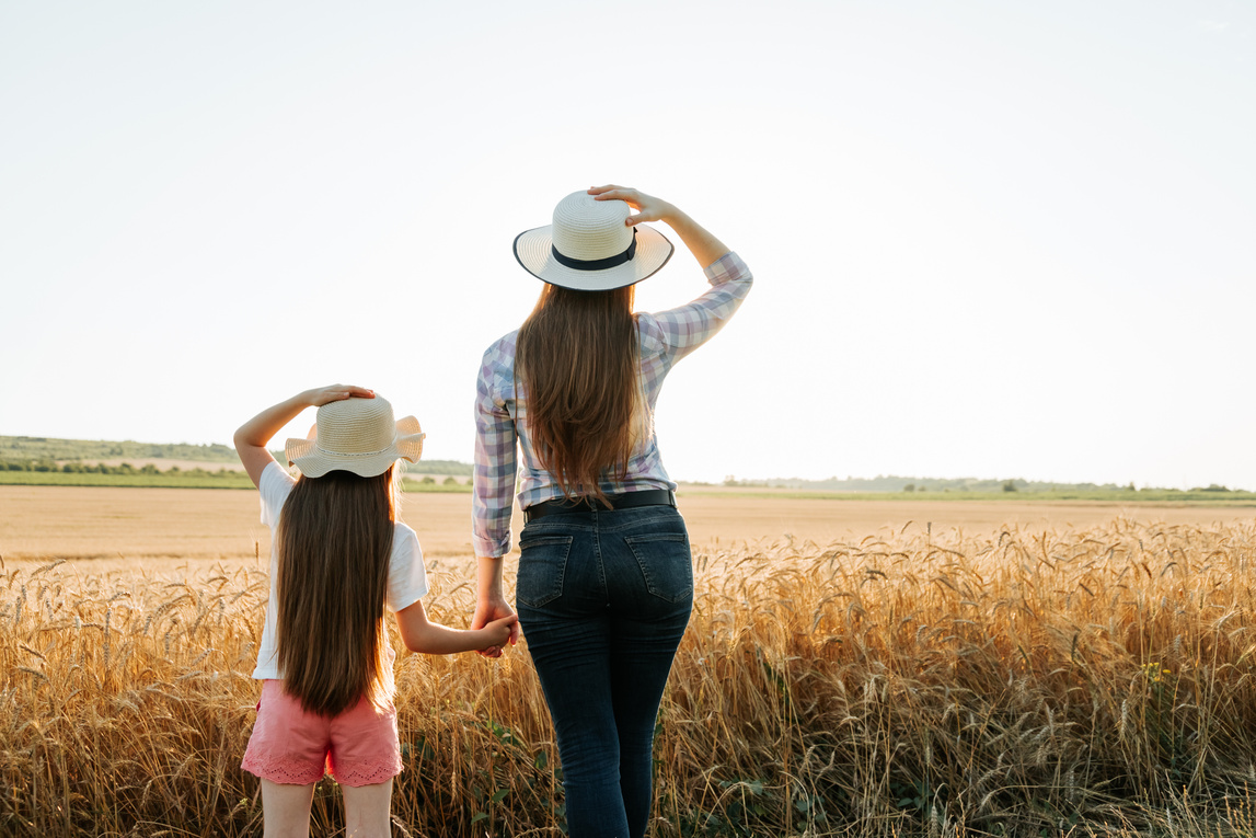 Rear view of family farmer woman and child